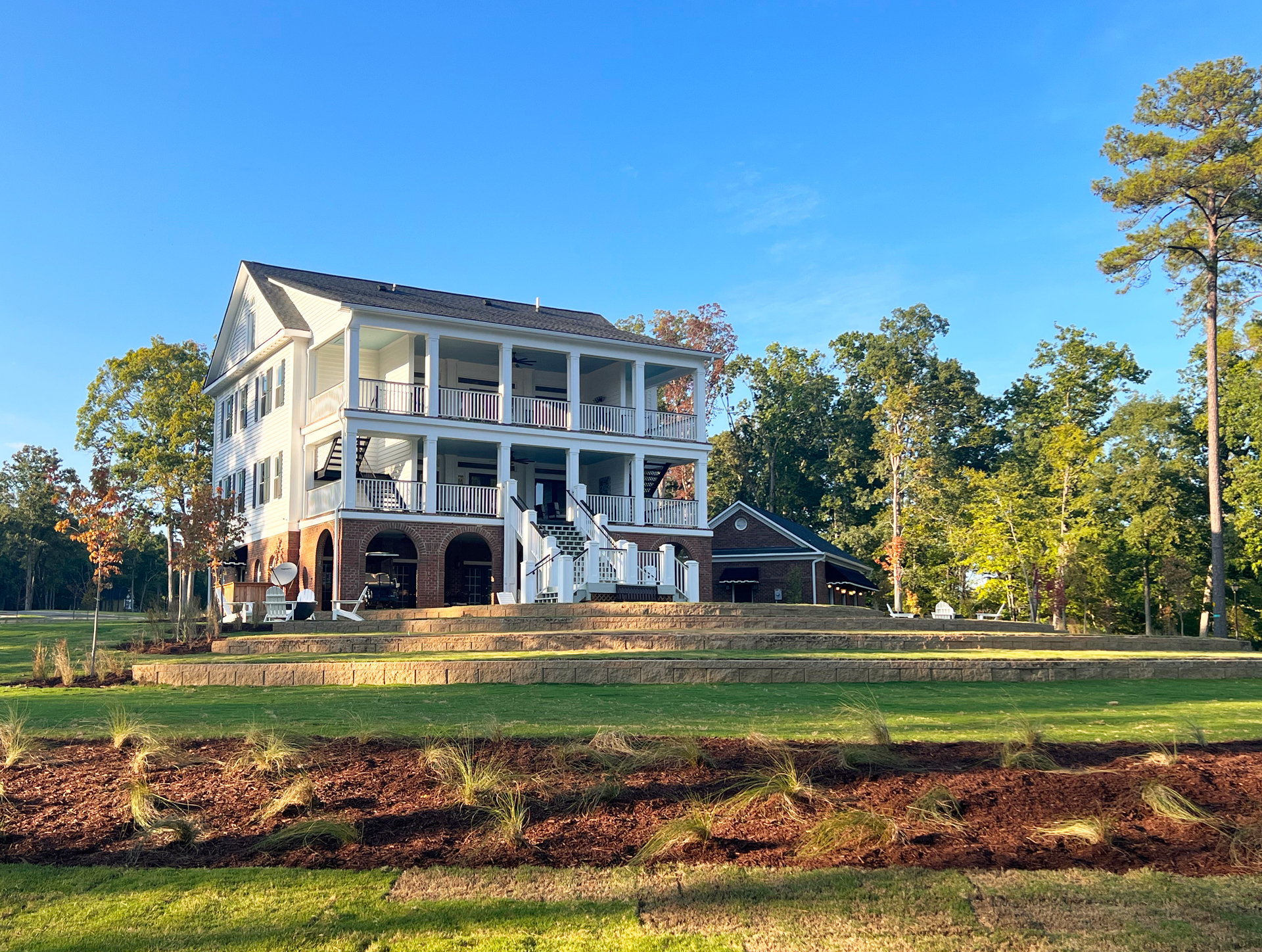 Exterior View from the Amphitheater to the Rear Entrance of the Clubhouse, Smart Gym & Yoga Lawn
