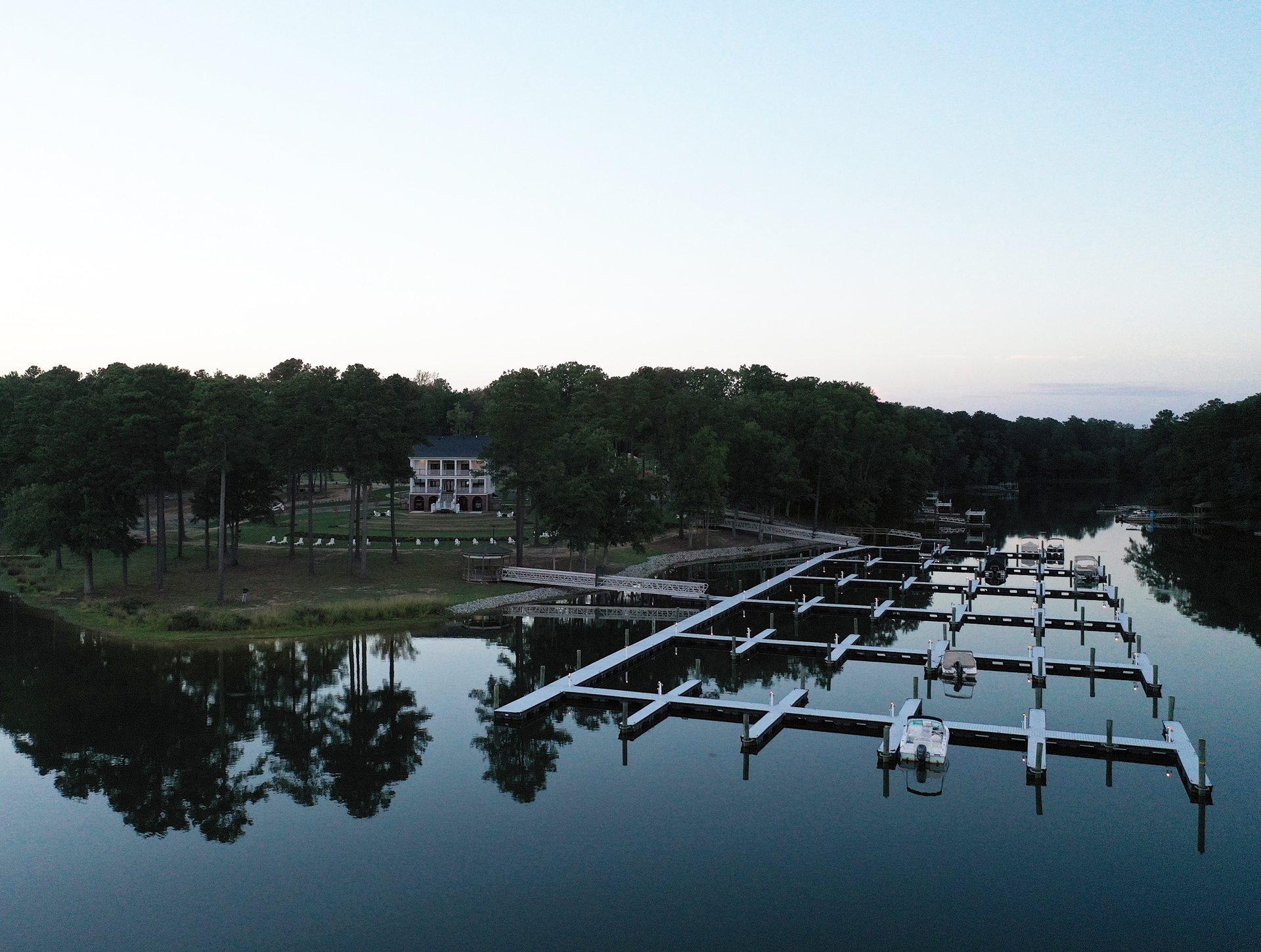 Aerial Views of the Amphitheater, Historic Clubhouse and Private Marina with Lights from the Water at Dusk